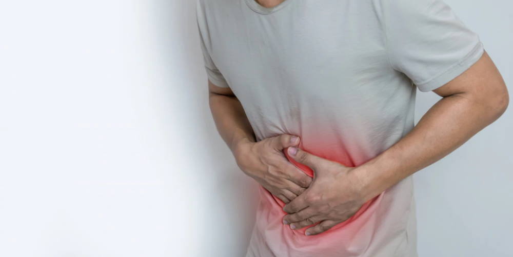 man holding stomach in pain